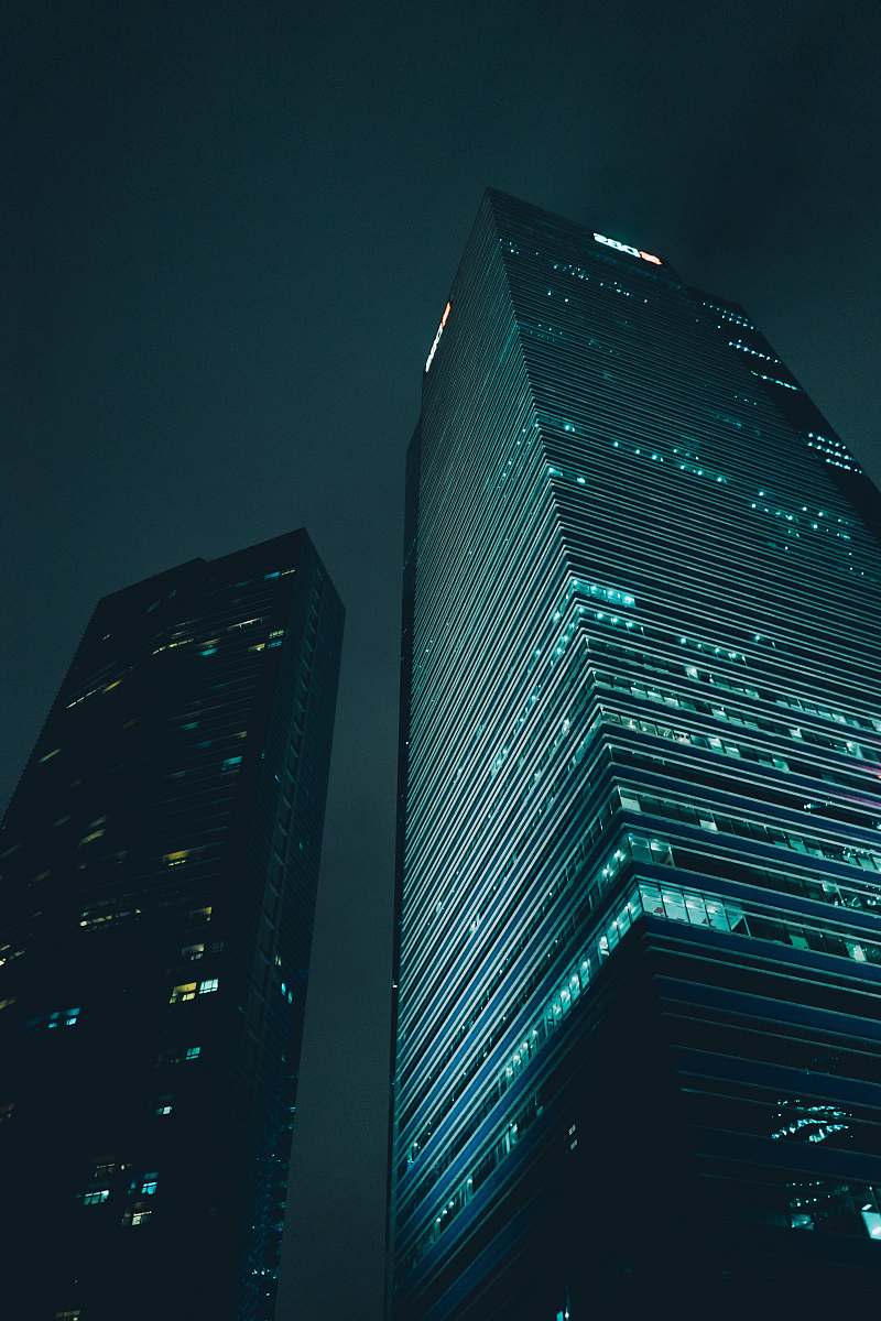 office building low-angle photography of high-rise buildings during nighttime city